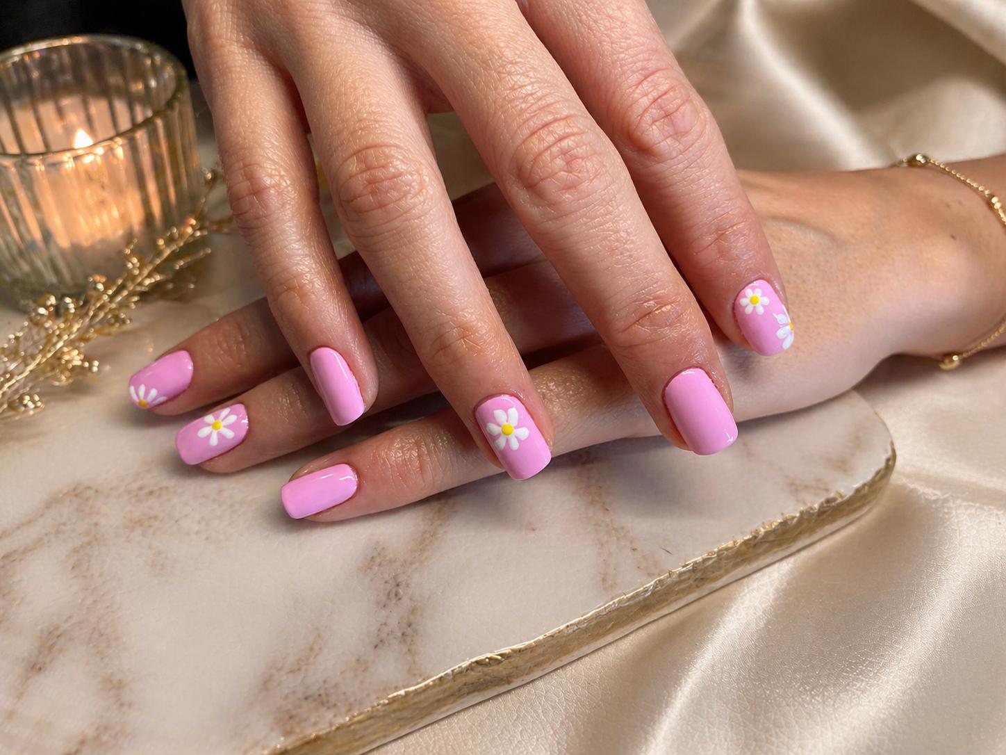Uñas rosas glossy con margaritas blancas